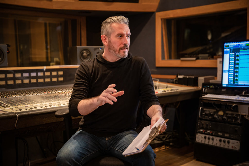 Owen Sartori producing in a music studio